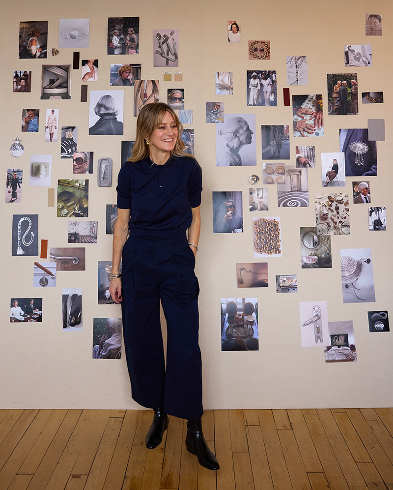 Jenny Bird stands in front of an inspiration wall