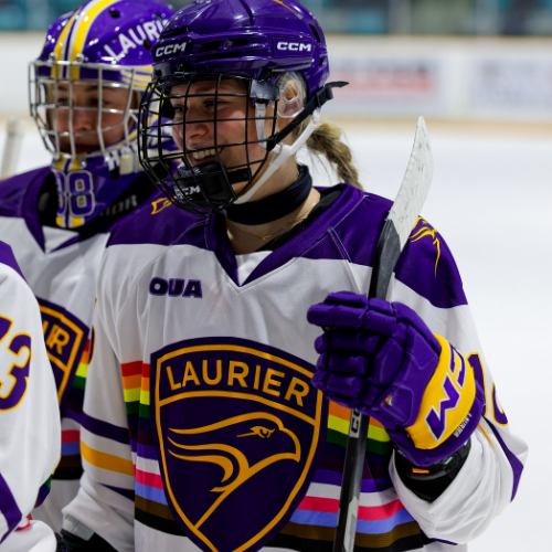 Laurier hockey player wearing a Pride jersey